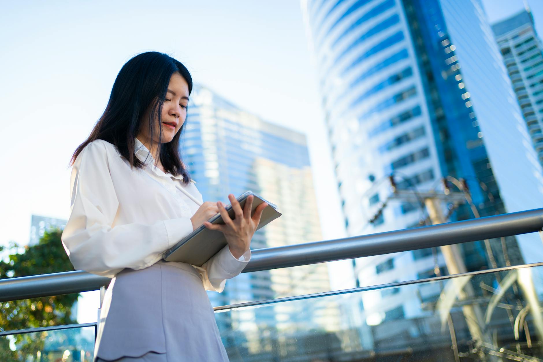 Businesswoman using tablet in modern Bangkok city. Vibrant and professional sett
